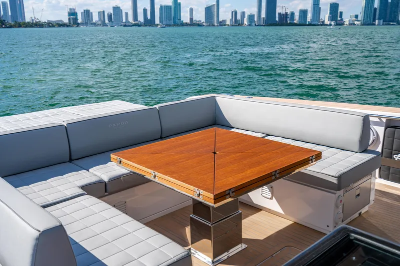 Slide: The Image of Luxurious 2023 Pardo 50 yacht with elegant seating and wooden table, overlooking city skyline. - 73