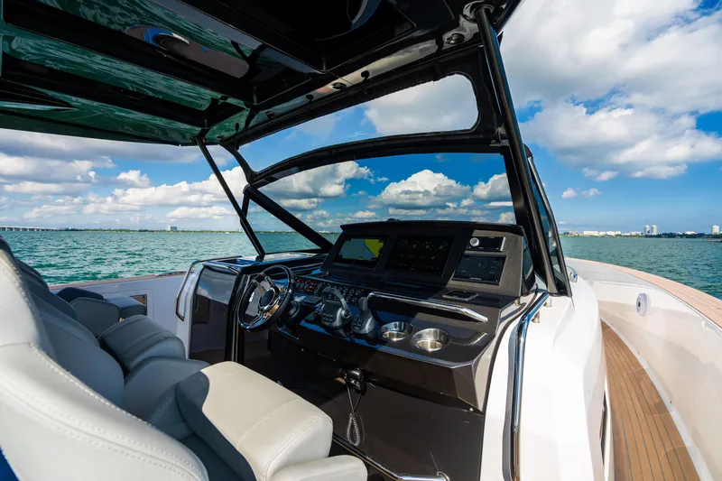 Slide: The Image of 2023 Pardo 50 yacht cockpit with modern controls, steering wheel, and ocean view. - 75