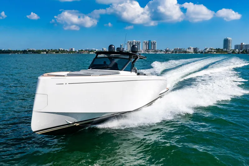 Slide: The Image of 2023 Pardo 50 yacht cruising on blue ocean with city skyline in background. - 8