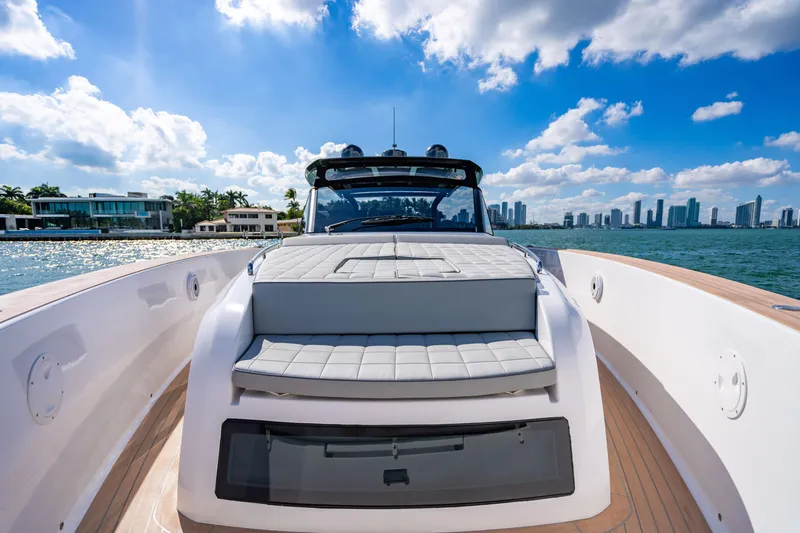 Slide: The Image of 2023 Pardo 50 yacht cruising near modern waterfront homes under a blue sky. - 89