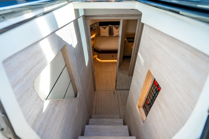 Slide: The Image of Luxurious interior of 2023 Pardo 50 yacht, featuring elegant wood finishes and cozy bedroom. - 95