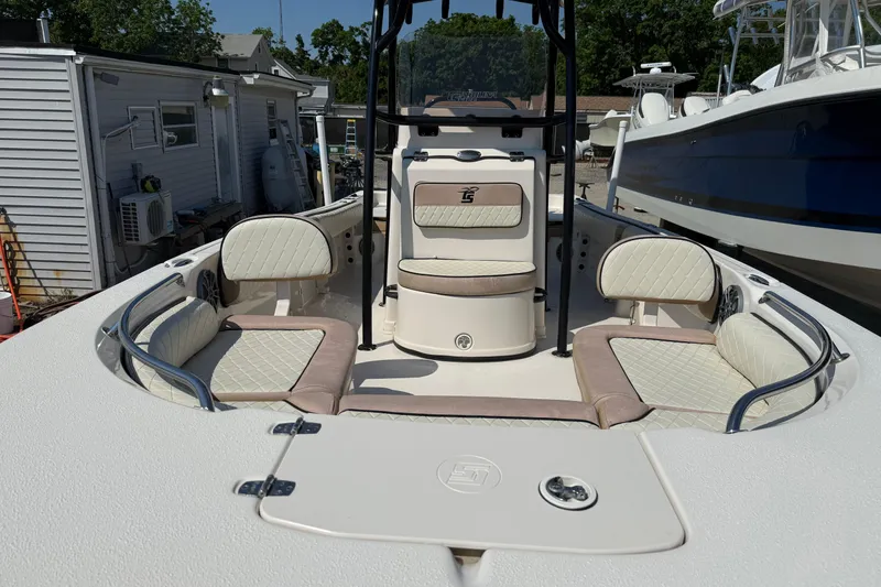 Slide: The Image of 2023 Carolina Skiff 21 Ultra Elite boat interior with cushioned seating and storage compartments. - 3