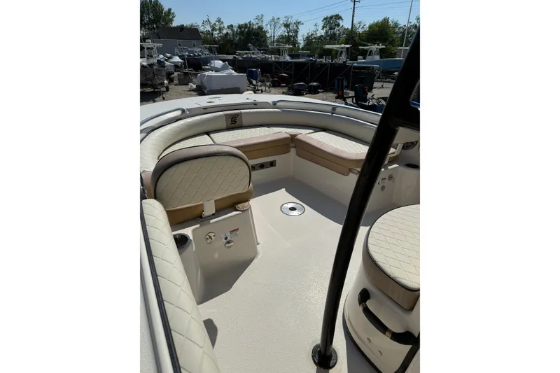 Slide: The Image of 2023 Carolina Skiff 21 Ultra Elite boat interior with cushioned seating and storage. - 4