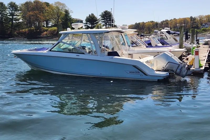The Image of 2021 Boston Whaler 320 Vantage boat docked on a sunny day. - 0