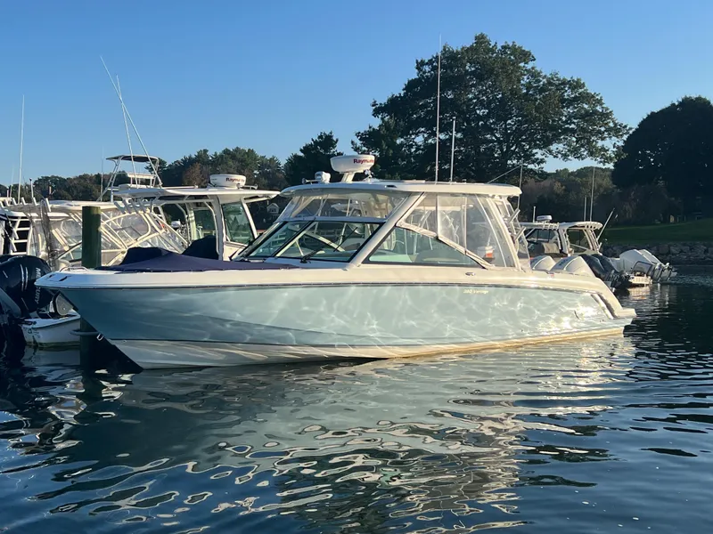 Slide: The Image of 2021 Boston Whaler 320 Vantage boat docked at sunset. - 1