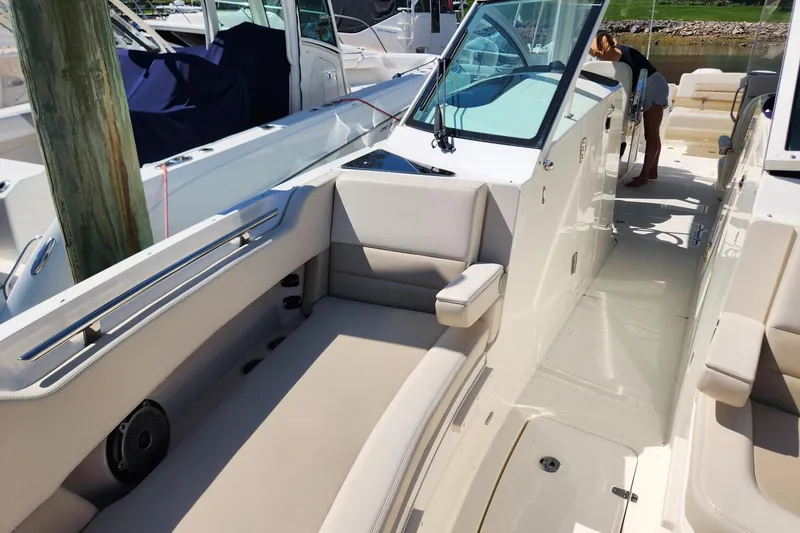 Slide: The Image of 2021 Boston Whaler 320 Vantage boat interior with seating and deck view. - 10
