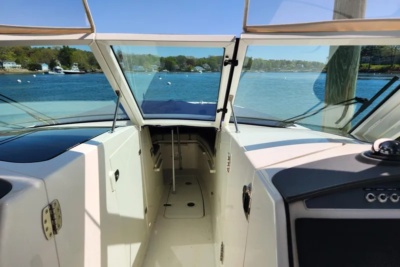 Slide: The Image of Boston Whaler 320 Vantage 2021 boat interior with open cabin and scenic water view. - 11
