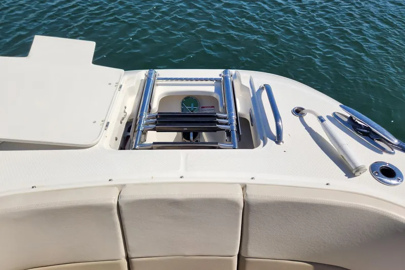 Slide: The Image of 2021 Boston Whaler 320 Vantage boat stern with ladder and seating, on water. - 15