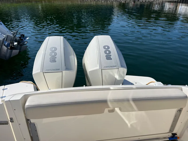 Slide: The Image of Boston Whaler 320 Vantage 2021 with twin outboard engines on calm water. - 16