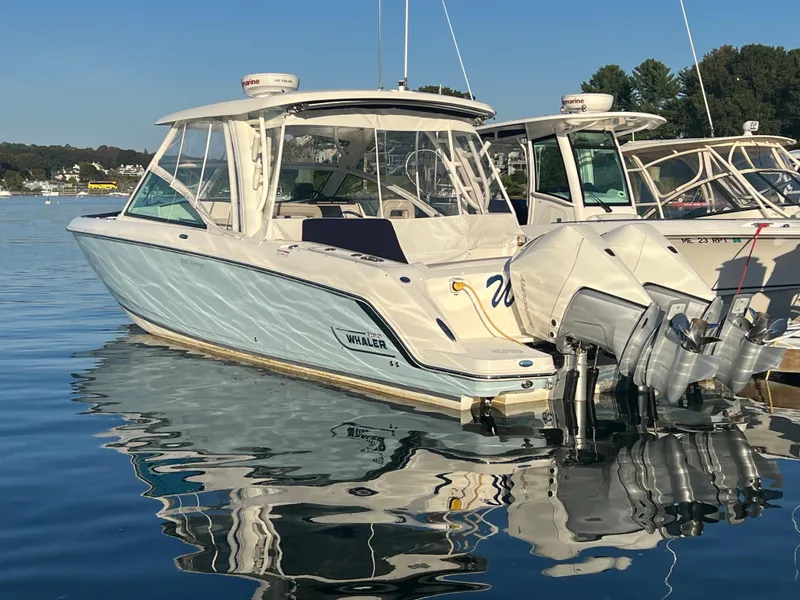 Slide: The Image of 2021 Boston Whaler 320 Vantage docked on water. - 2