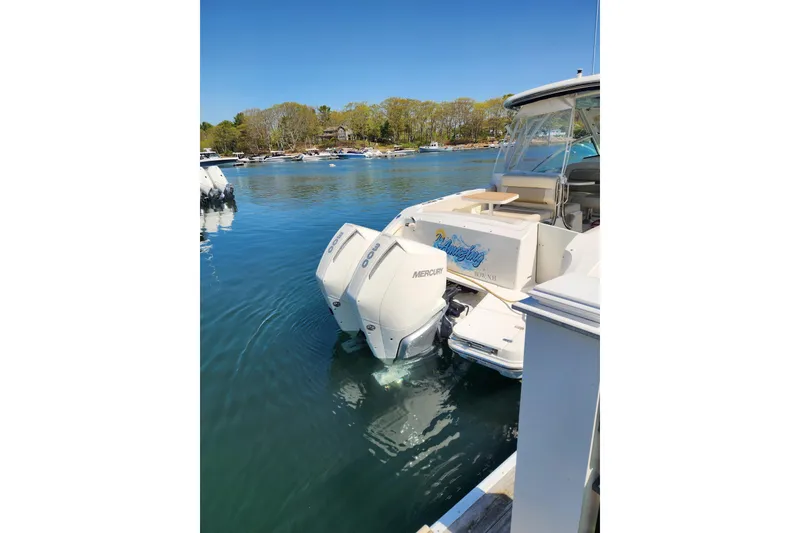 Slide: The Image of 2021 Boston Whaler 320 Vantage docked with twin Mercury outboard engines. - 3