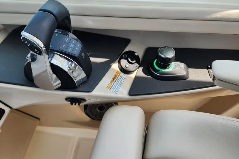 Slide: The Image of Control panel of a 2021 Boston Whaler 320 Vantage boat, featuring throttle and joystick. - 7