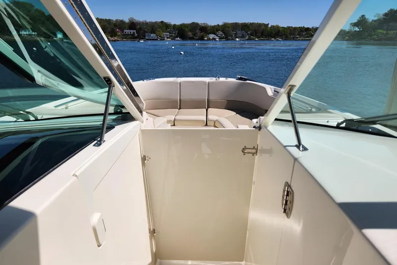 Slide: The Image of 2021 Boston Whaler 320 Vantage boat interior with open deck and scenic water view. - 8