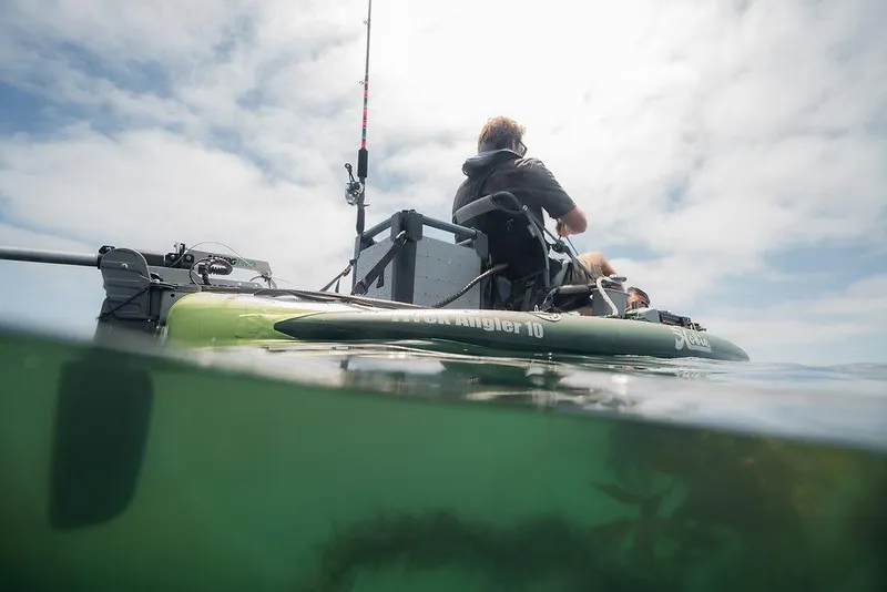 Slide: The Image of Person fishing on a 2026 White River iTrek Angler 10 inflatable kayak in calm waters. - 5