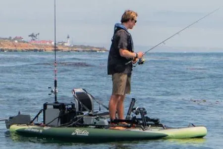 Slide: The Image of Man fishing on a 2026 White River iTrek Angler 10 Inflatable kayak in open water. - 6