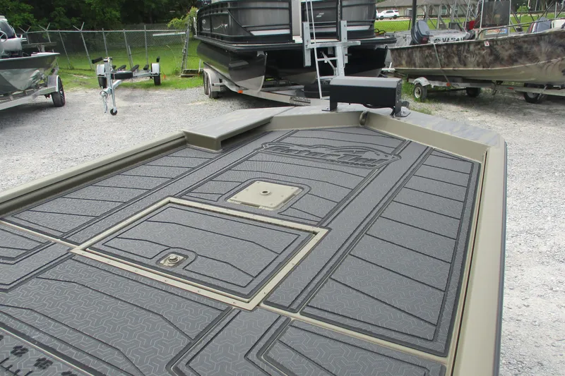 Slide: The Image of 2026 Gator Tail 2060 Extreme CC boat deck with textured flooring, parked outdoors. - 13