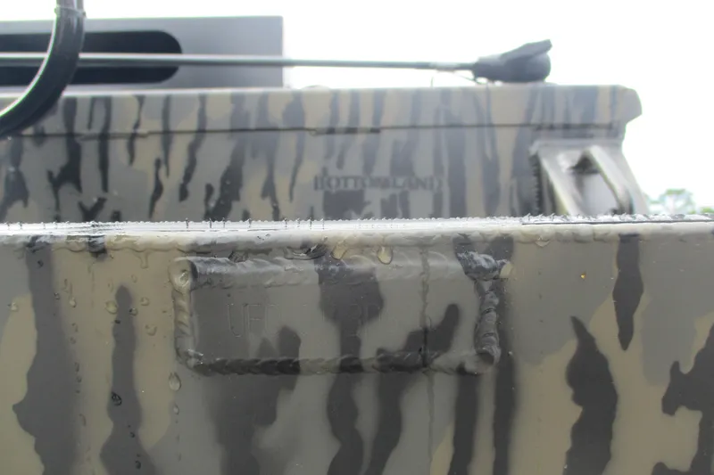 Slide: The Image of Close-up of 2026 Gator Tail 2060 Extreme CC boat with camouflage pattern and water droplets. - 14