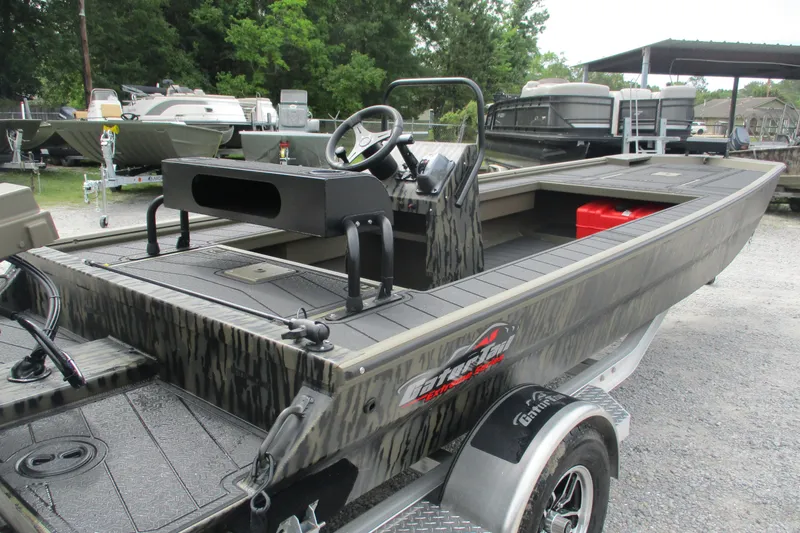 Slide: The Image of 2026 Gator Tail 2060 Extreme CC boat on trailer, featuring camouflage design and steering console. - 2