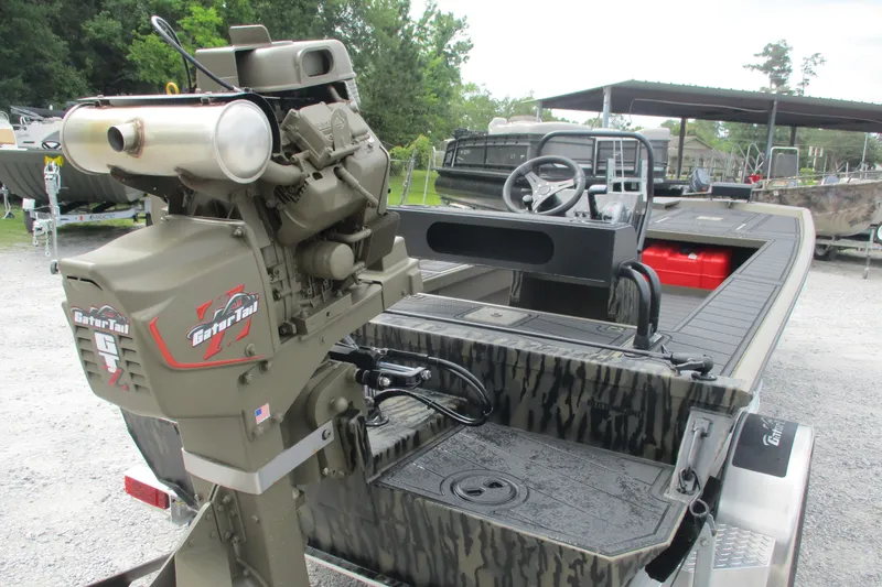 Slide: The Image of 2026 Gator Tail 2060 Extreme CC boat with powerful outboard motor, camo design, and steering console. - 7