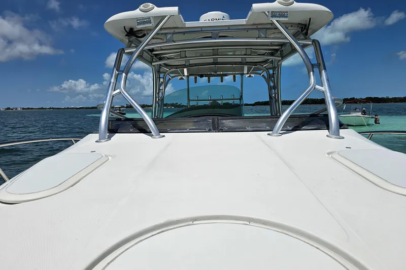 Slide: The Image of 2005 Hydra-Sports Vector 3300 VX boat on water, clear sky background. - 10