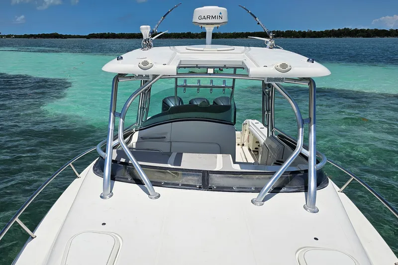 Slide: The Image of 2005 Hydra-Sports Vector 3300 VX boat on clear turquoise water, featuring Garmin equipment. - 11