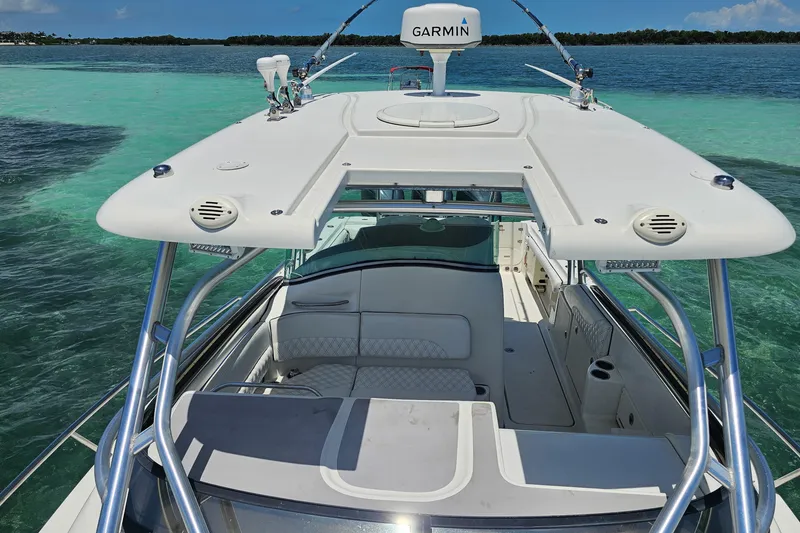 Slide: The Image of 2005 Hydra-Sports Vector 3300 VX boat on clear turquoise water, featuring Garmin equipment. - 12
