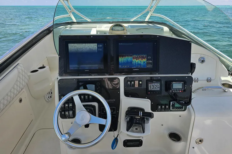 Slide: The Image of 2005 Hydra-Sports Vector 3300 VX helm with navigation screens and steering wheel. - 15