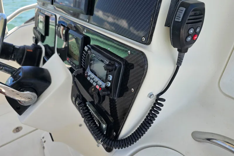 Slide: The Image of Control panel of a 2005 Hydra-Sports Vector 3300 VX boat with communication equipment. - 16
