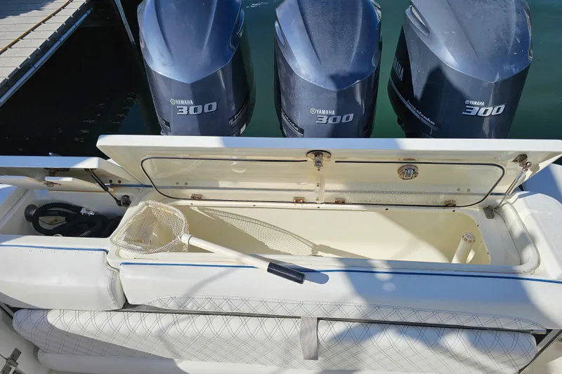 Slide: The Image of 2005 Hydra-Sports Vector 3300 VX boat with Yamaha 300 engines and open storage compartment. - 23