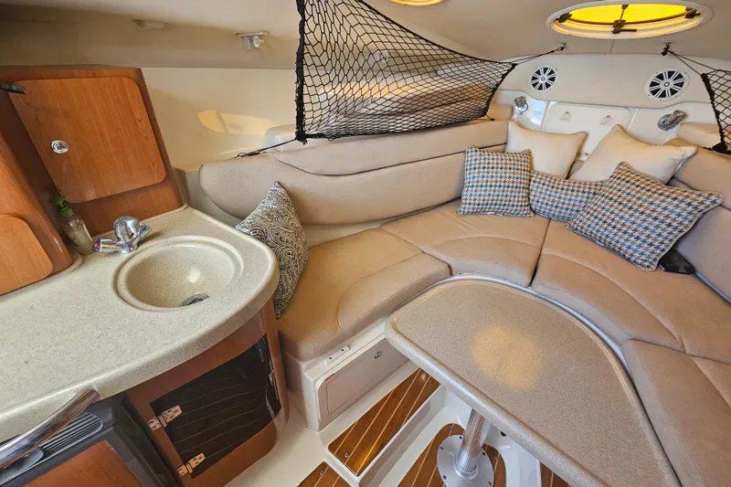 Slide: The Image of 2005 Hydra-Sports Vector 3300 VX cabin interior with cozy seating and kitchenette. - 27