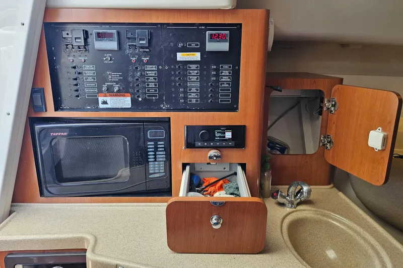 Slide: The Image of 2005 Hydra-Sports Vector 3300 VX cabin with control panel, microwave, and sink. - 29