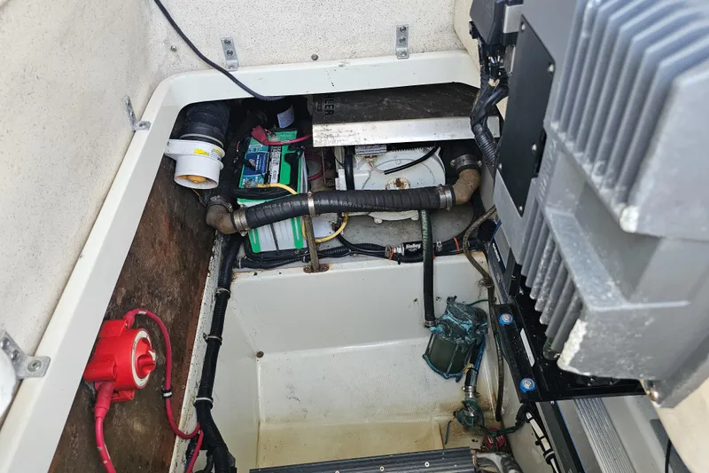 Slide: The Image of Engine compartment of a 2005 Hydra-Sports Vector 3300 VX boat, showing battery and wiring. - 31