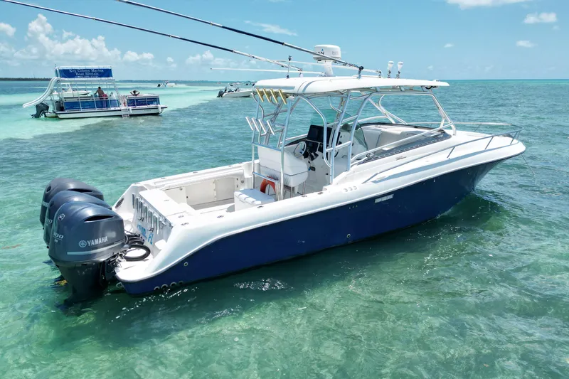 Slide: The Image of 2005 Hydra-Sports Vector 3300 VX boat with twin Yamaha engines on clear turquoise water. - 5