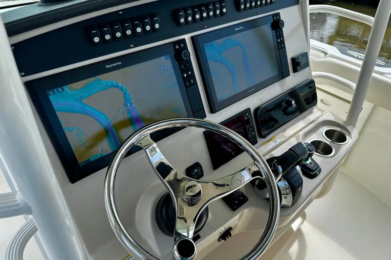 Slide: The Image of 2019 Boston Whaler 330 Outrage helm with dual Raymarine displays and stainless steel steering wheel. - 10