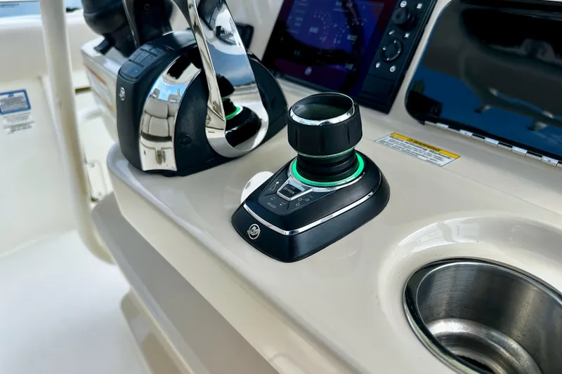 Slide: The Image of Control panel of a 2019 Boston Whaler 330 Outrage boat, featuring joystick and throttle. - 12