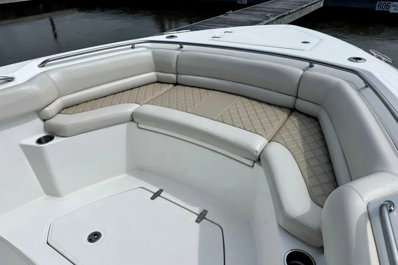 Slide: The Image of Luxurious seating area on a 2019 Boston Whaler 330 Outrage boat, featuring elegant upholstery. - 18