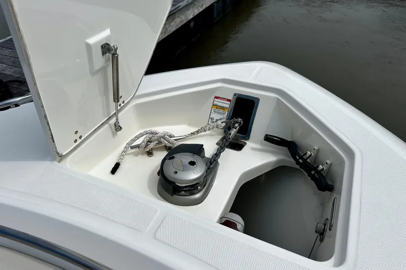 Slide: The Image of 2019 Boston Whaler 330 Outrage anchor compartment with rope and chain storage. - 21