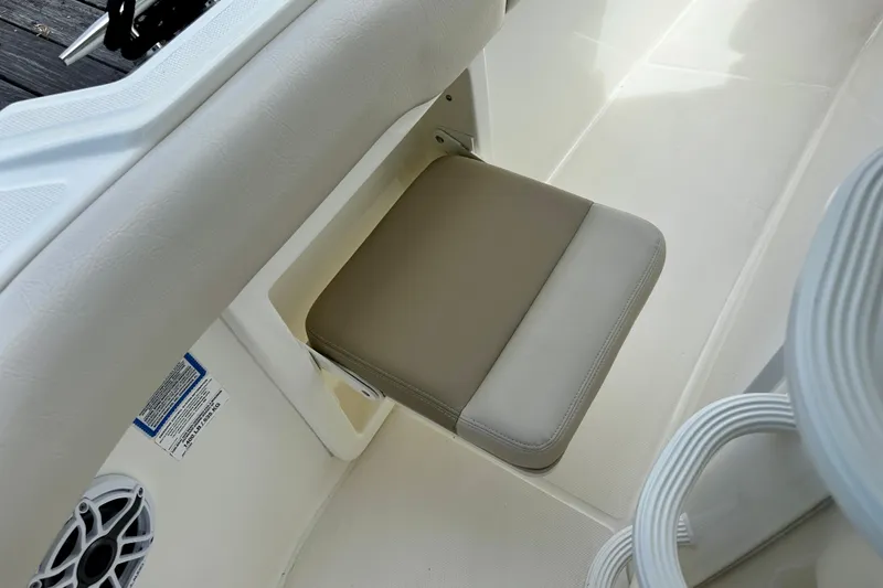 Slide: The Image of 2019 Boston Whaler 330 Outrage boat seat detail with beige cushion. - 22