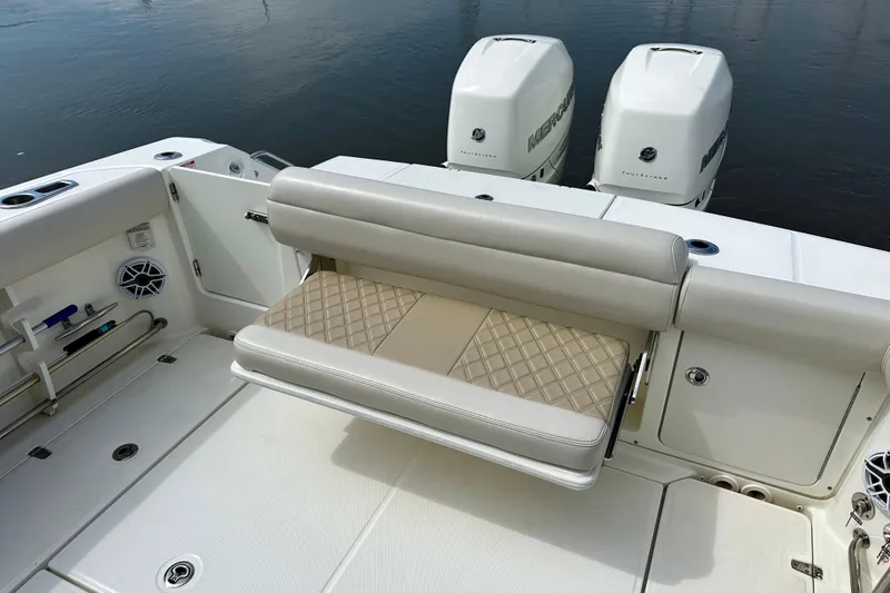 Slide: The Image of 2019 Boston Whaler 330 Outrage boat with cushioned seating and dual Mercury engines. - 23