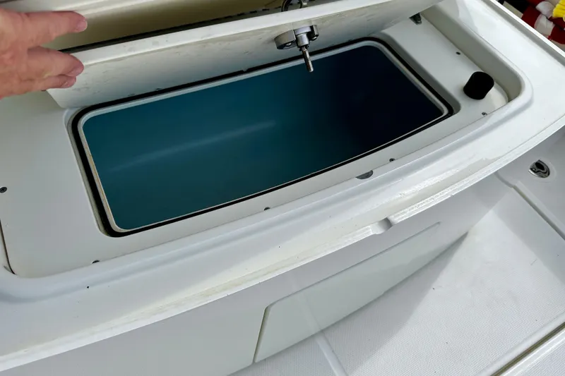 Slide: The Image of Open storage compartment on a 2019 Boston Whaler 330 Outrage boat. - 25