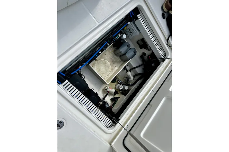 Slide: The Image of 2019 Boston Whaler 330 Outrage engine compartment with visible components and wiring. - 28