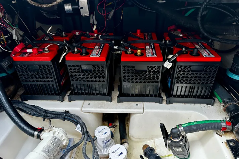 Slide: The Image of Battery compartment of a 2019 Boston Whaler 330 Outrage, featuring multiple marine batteries. - 31