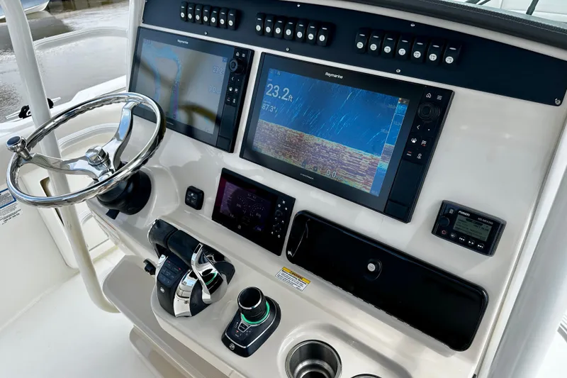 Slide: The Image of 2019 Boston Whaler 330 Outrage helm with advanced navigation displays and controls. - 9