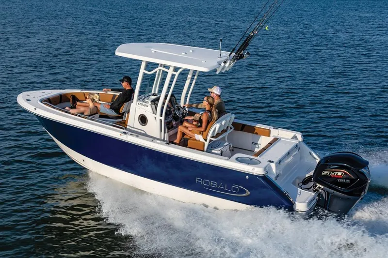 Slide: The Image of Manufacturer Provided Image: 2025 Robalo R230 Center Console boat cruising on open water. - 2