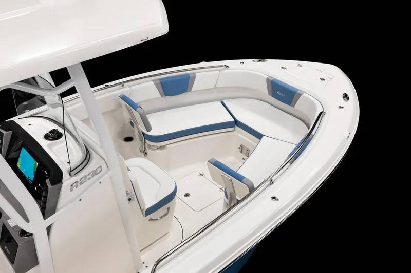 Slide: The Image of Manufacturer Provided Image: 2026 Robalo R230 Center Console boat interior with blue and white seating. - 6