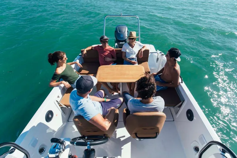 Slide: The Image of People relaxing on a 2024 Beneteau Flyer 8 SPACEdeck boat in the ocean. - 10