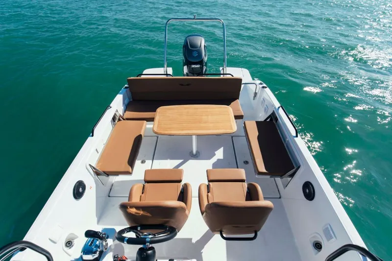 Slide: The Image of 2024 Beneteau Flyer 8 SPACEdeck boat interior with seating and table on water. - 11