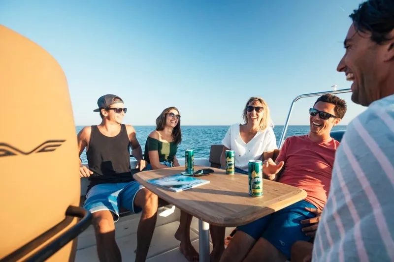 Slide: The Image of Friends enjoying drinks on a 2024 Beneteau Flyer 8 SPACEdeck boat. - 24