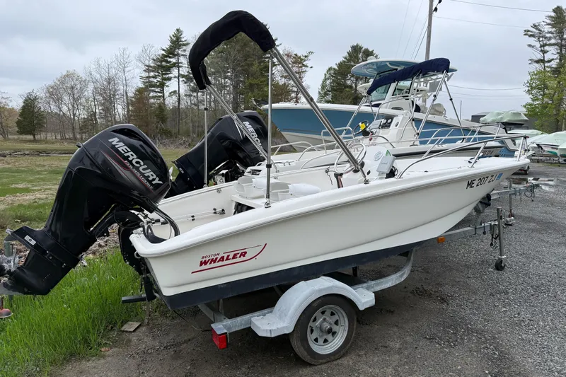 Slide: The Image of 2016 Boston Whaler 130 Super Sport boat with Mercury engine on trailer. - 1