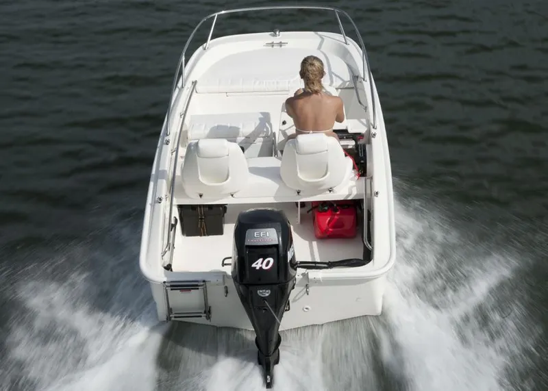 Slide: The Image of Manufacturer Provided Image: 2016 Boston Whaler 130 Super Sport boat cruising on water, rear view. - 6